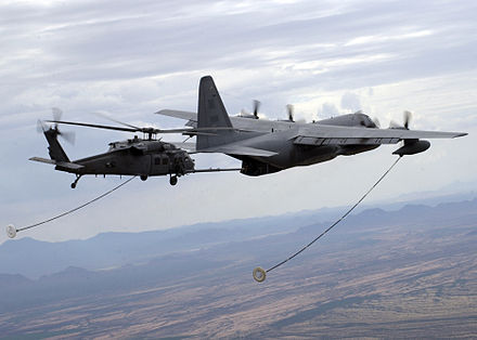 A USAF HC-130P refuels a HH-60G Pavehawk helicopter