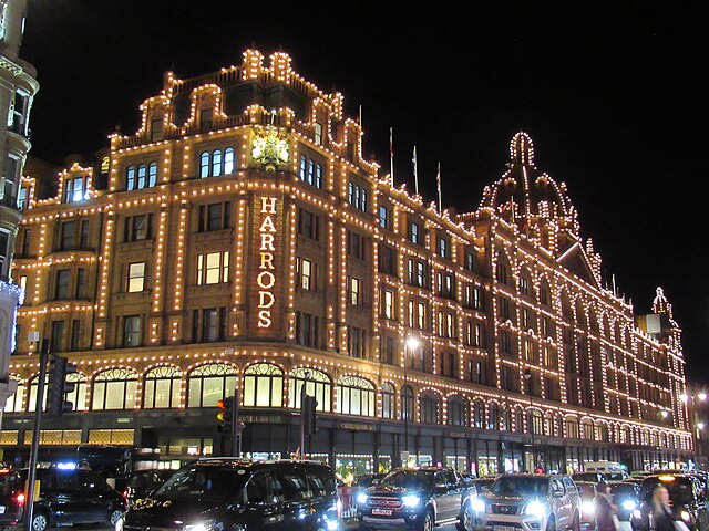 Harrods illuminated exterior at night in Knightsbridge, London