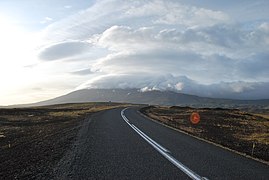 Between the two villages, the mountain is partially covered by clouds.