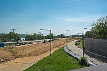 Looking southwest from Barney Circle at decommissioned Interstate 695. The roadway is being torn up and the road bed raised by 20 feet to create a new road to be named "Southeast Boulevard". The now-closed on-ramp from Pennsylvania Avenue SE can be seen to the left. I-695 deconstruction - Washington DC.jpg