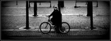 A cyclist at Salford Quays Lady on a bike (7663167476).jpg