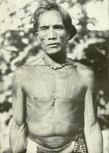 Lakay Wanawan of the Kalinga people (c.1912), a renowned warrior and later a pangat
(tribal elder). Note the biking
chest tattoos and the face tattoos. Lakay Wanawan - Kalinga people (c.1912).png