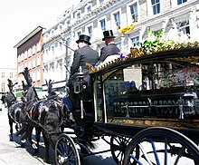 Funeral directors driving a hearse in a funeral procession McLaren cortege.JPG