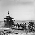 Men of the 1st Battalion, 183rd Infantry embarking aboard USS LCI(L)-74 at Aitape, New Guinea, circa 15 to 18 May 1944