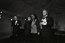 John (second from left) alongside British Prime Minister Tony Blair (left), singer-songwriter Stevie Wonder and U.S. President Bill Clinton at the White House, February 1998