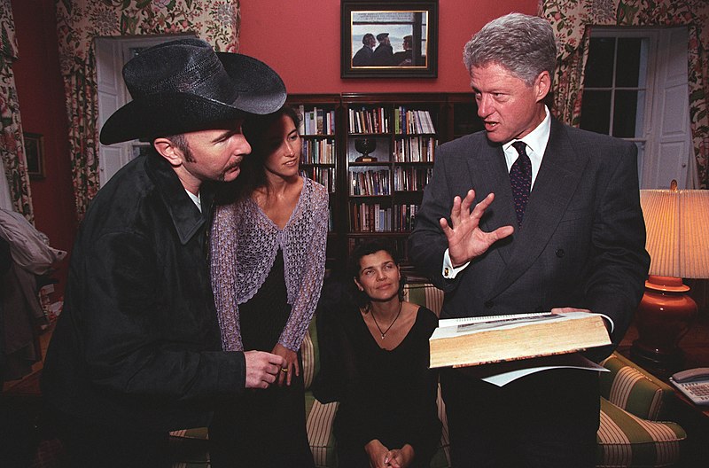 File:President Bill Clinton and musician the Edge look at a book.jpg