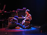 David Sitek with a wind chime suspended from his guitar. Sitek wind chimes.jpg