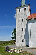 Skjee kirke (12c. church) Stokke Sandefjord Norway, tower (tarn), cemetery (kirkegard), funeral flowers wreaths Sunny Blue sky Etc 2019-05-16 DSC02065.jpg