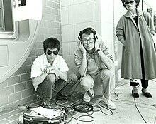Sound recordist Curtis Choy (left) on location for Dim Sum: a Little Bit of Heart, an indie film by director Wayne Wang (center) on Clement Street in the Richmond District of San Francisco, California 1983 Sound recordist Curtis Choy.jpg