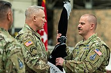 Gen LaCamera (center) passes the SPACEFORKOR flag to Lt Col McCullion as Brig Gen Mastalir looks on during the activation of the unit, 14 December 2022 Space Force activates component field command for U.S. Forces Korea (1).jpg