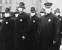 Seattle policemen in 1918 during the Spanish flu pandemic Spanish flu in 1918, Police officers in masks, Seattle Police Department detail, from- 165-WW-269B-25-police-l (cropped).jpg