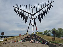 The Sculpture Bird adorned with children's shoes in June 2021. Spirit Catcher with shoes 2021.jpg