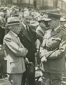 UAP Minister and veteran World War I Prime Minister Billy Hughes (left) with Richard Casey and John Lavarack c. 1933. Hughes opposed the policy of "appeasement" favoured by the Western powers and warned of an Australia ill-prepared for the coming war. StateLibQld 1 249505 J.D. discussing the Depression with Billy Hughes and Dick Casey.jpg