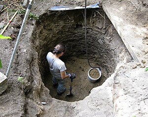 Excavating a large stone-lined urban privy during a major property renovation (c. 1851). Stone privy well.jpg