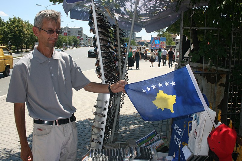 File:Street vendor shows off the new Kosovo flag.jpg