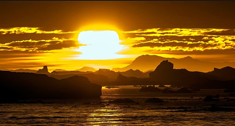 File:The sun sets over a graveyard of icebergs... (8369434877).jpg