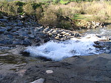 An artificial concrete waterfall on Arroyo Trabuco, downstream of the Metrolink rail bridge and upstream of the Oso Creek confluence