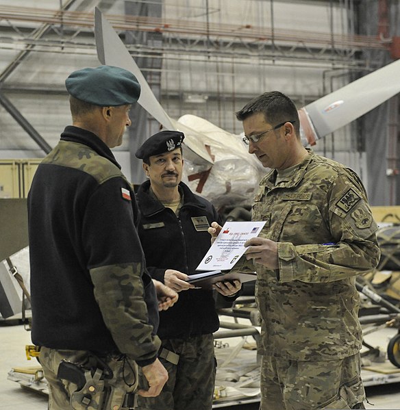 File:U.S. Air Force Master Sgt. James Simmons, right, assigned to the 455th Expeditionary Aircraft Maintenance Squadron, receives a certificate of appreciation from Polish air force Col. Andrzej Kusneierek, left 140103-F-BJ707-015.jpg