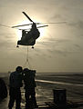 A CH-46 Sea Knight delivers supplies to a U.S. Navy ship in July 2002.