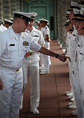 U.S. Naval Academy Midshipman being inspected wearing Summer Whites (2010) US Navy 100406-N-3879H-052 Senior Chief Quartermaster James Kuroski inspects U.S. Naval Academy midshipman during a brigade summer whites uniform inspection.jpg