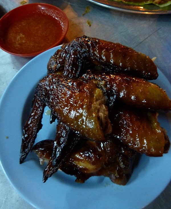A plate of juicy chicken wings from a stall on Jalan Alor