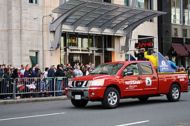 The entrance to Mandarin Oriental, Boston, as a pace truck for the 2013 Boston Marathon passes by.