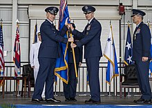 Schneider (center right, holding flag) assumes command of Pacific Air Forces on February 9, 2024. 2024 PACAF Change of Command 240209-F-IP756-1566.jpg