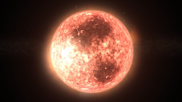 Illustration depicting AU Mic, an M-type (spectral class M1Ve) red dwarf star less than 0.7% the age of the Sun. The dark areas represent huge sunspot