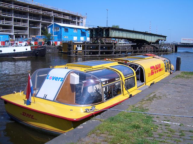 DHL boat in Amsterdam, carrying DHL delivery bicycles on board