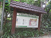 A map signage surrounded by trees.