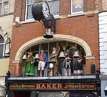 Automaton clock in Gloucester. The figures striking the quarter hours and the chimes represent the constituent countries of the United Kingdom. They are (L-R) Northern Ireland, England, Scotland and Wales. In the centre is Old Father Time, who strikes the hours. Automaton.JPG