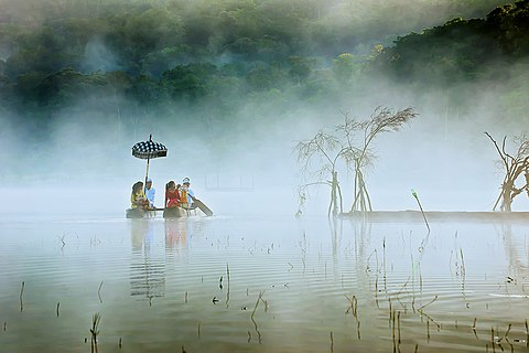 Peoples in Lake Tamblingan, Bali use traditional boats to cross. They left early in the morning to pray at the temple