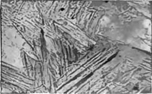 Photomicrograph of martensite, a very hard microstructure formed when steel is quenched. Tempering reduces the hardness in the martensite by transform