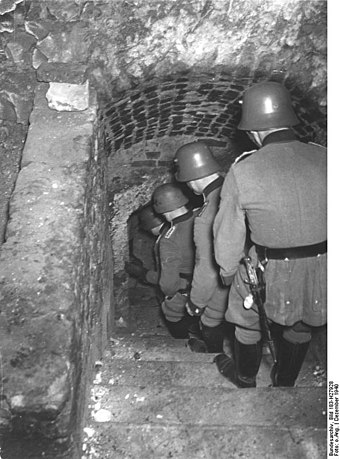 Order Police descending to the cellars on a Jew-hunt in Lublin, December 1940. The Lublin Ghetto was set up in March 1941