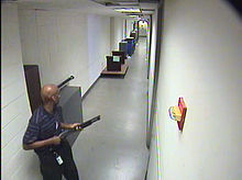 Aaron Alexis holding a shotgun during his rampage CCTV 1 of Aaron Alexis in building 197.jpg