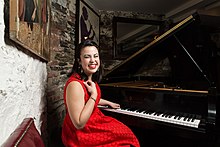 Champian Fulton in a red dress at a grand piano Champian at the Piano.jpg
