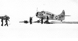 VX-6 crew members assembling a United States Navy UC-1 Otter aircraft at McMurdo Station. The XD tail code is clearly visible. This aircraft crashed on takeoff near Cape Bird, Ross Island, on 2 December 1955. Note the HO4S-3 in the left background. Deepfreeze I 046a.jpg