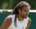 Dustin Brown competing in the second round of the 2015 Wimbledon Qualifying Tournament at the Bank of England Sports Grounds in Roehampton, England. The winners of three rounds of competition qualify for the main draw of Wimbledon the following week.