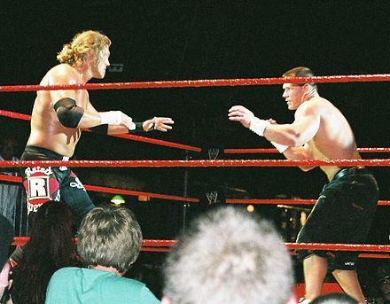 Edge facing off against John Cena during a WWE house show