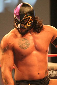 El Hijo del Fantasma defeated Drake Maverick to become Interim Champion. During his reign he would unmask and change his name to Santos Escobar. El Hijo de Fantasma BFG 17 crop.jpg