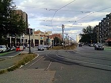 Former stub remains of A branch tracks at Packards Corner. The switch was disconnected in 2014 and paved over in 2020. Green Line A Branch, disconnected switch, September 2014.jpg