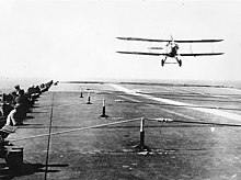 Fairey III-F aircraft landing on board British aircraft carrier HMS Furious circa early 1930s. Arresting gear wires are visible above the flight deck