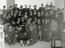 British servicemen and women hosted by Maltese Jewish families, 1940-41. Sitting on the floor: Fortunato Habib, George Tayar (talking), Marco Aroyo. Hosting the troops.jpg