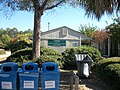 The vending machine booth is behind these recycling bins.