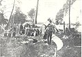 Indian families building birch bark canoes on Sandy Point, Ely. Man gumming canoe is Chief Blackstone. (Wm. Trygg) ca. 1900 (5187472799).jpg