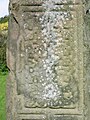 English: The Broken Cross is one of the five high crosses in Kells, County Meath, Ireland. It may have been the tallest high cross ever. It may have been broken by Oliver Cromwell's army, which used the church as stables. Here is the bottom-middle of the southern face. Français : La Croix brisée est l’une des cinq hautes croix de Kells, ville irlandaise du comté de Meath. Elle a peut-être été la plus imposante haute croix. Elle aurait été brisée par les armées d’Oliver Cromwell, qui stationnaient leurs chevaux dans l’ancienne église. Ici, on voit le milieu-bas de la face sud.