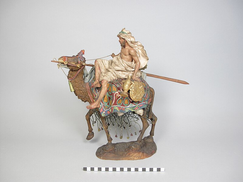 File:Men riding a camel.JPG