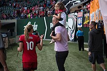 Paulson (right) with his daughter, and former Thorns FC player Allie Long in 2016 Merritt Paulson with Allie Long (29431155416).jpg