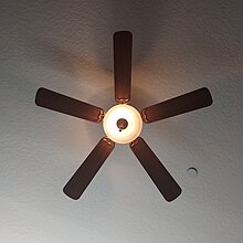 A modern pull-chain operated ceiling fan with its light on Modern ceiling fan.jpg