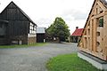 Vogtland open-air museum Landwüst, courtyard I: with the Wunderlich residential house (house 1), the remise building from Siebenbrunn (house 2) and Wunderlich barn (house 3) as well as beehives (at house 3)